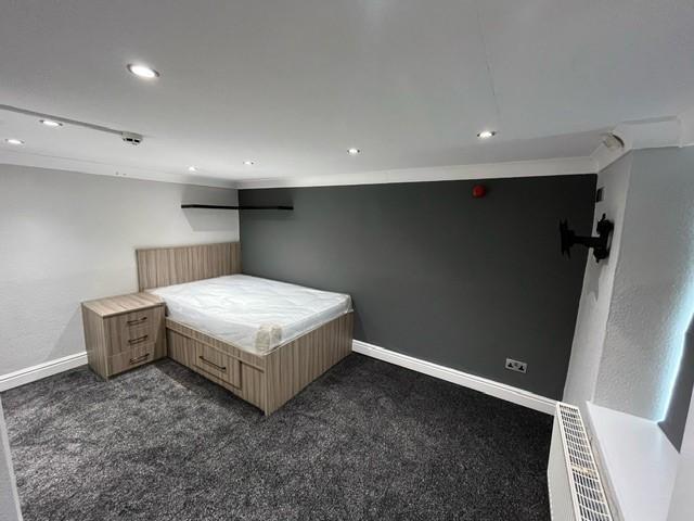 A well-maintained bedroom featuring a double be...
