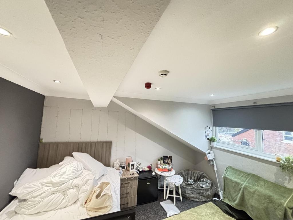 Bright and cozy bedroom with large windows allo...