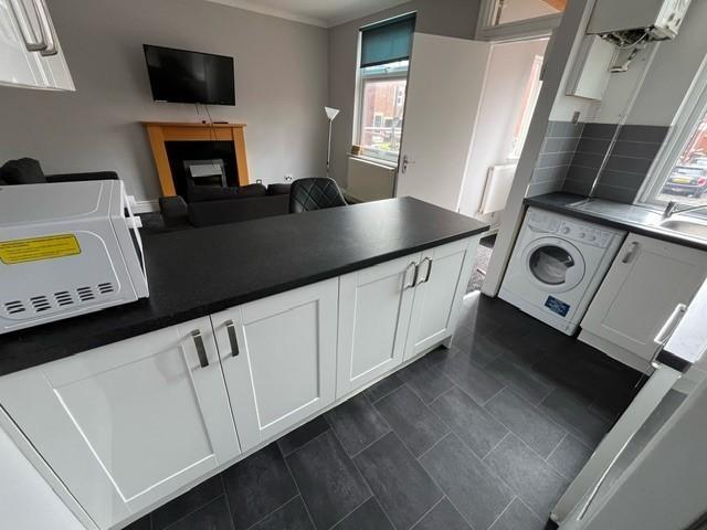 A bright, modern kitchen with ample workspace, ...