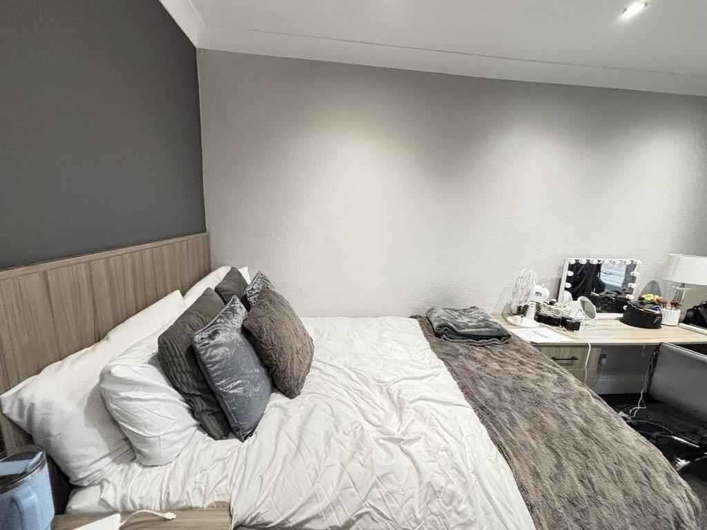 A well-maintained bedroom featuring a comfortab...