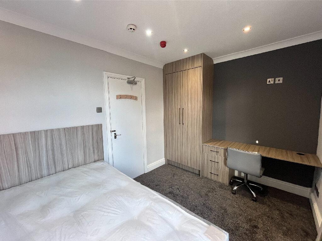 A modern, well-maintained bedroom featuring nat...
