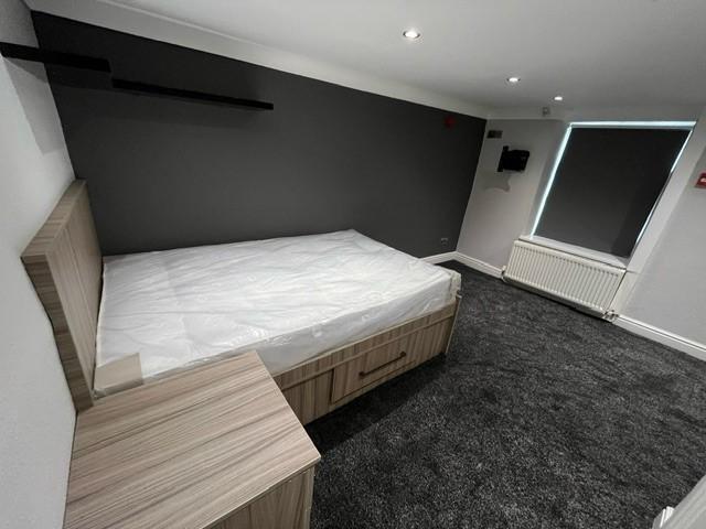 A well-maintained double bedroom featuring a la...