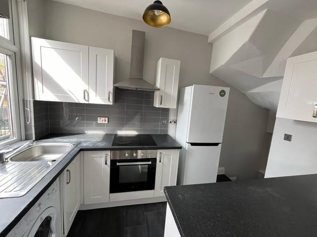 A modern, well-maintained kitchen featuring whi...