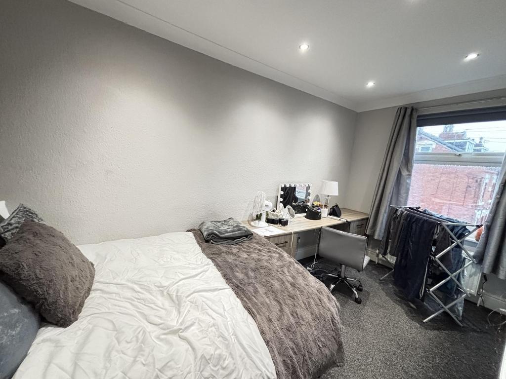 A well-maintained bedroom featuring a cozy doub...