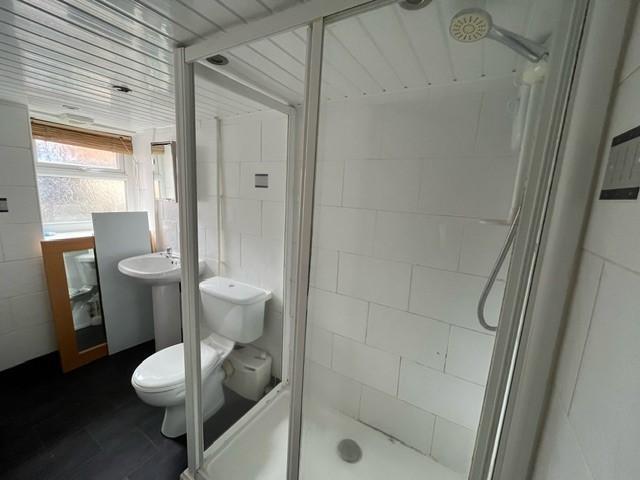 A clean and modern bathroom with a shower enclo...