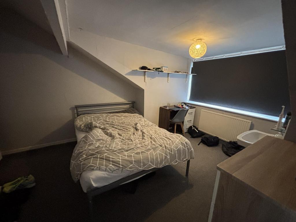 A cozy bedroom with a double bed positioned und...