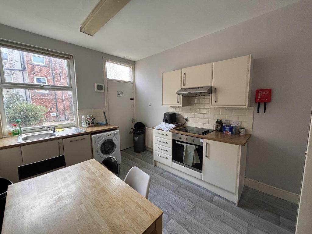 A bright and tidy kitchen with ample natural li...