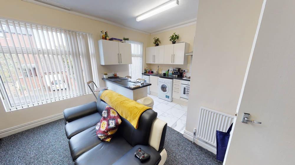 Bright and welcoming living room with ample nat...