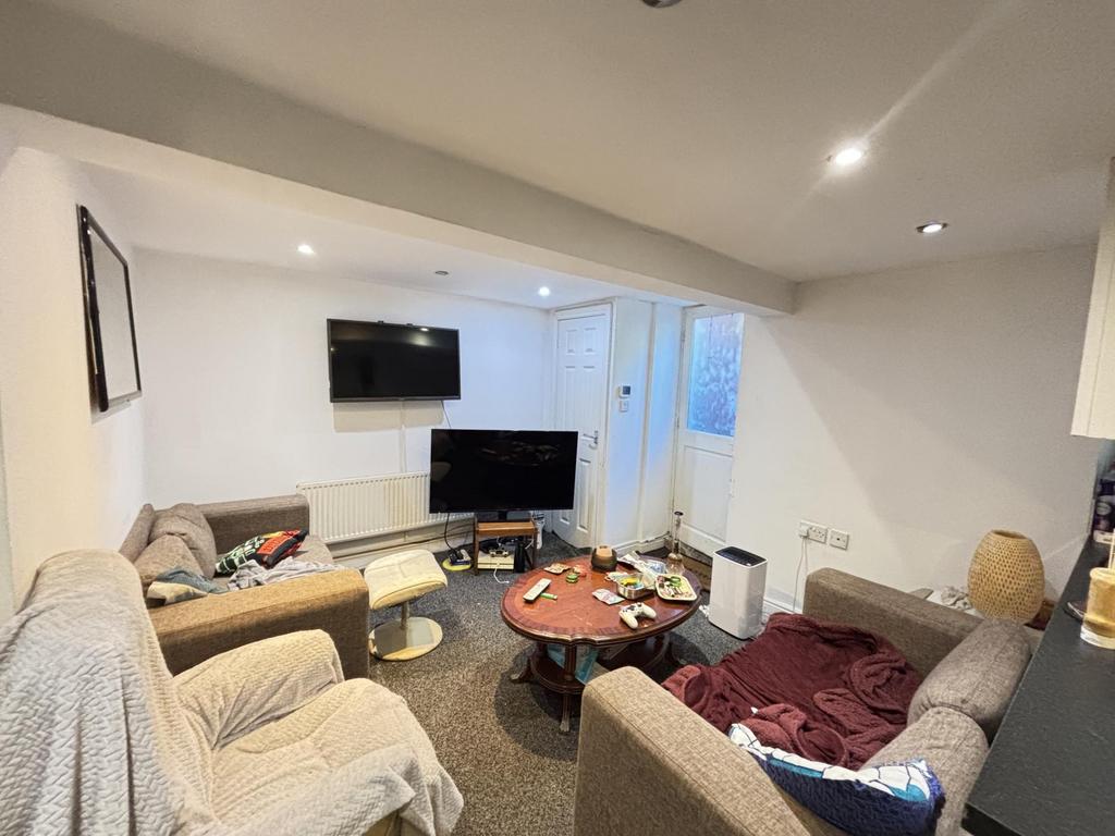 A spacious and modern living room featuring com...