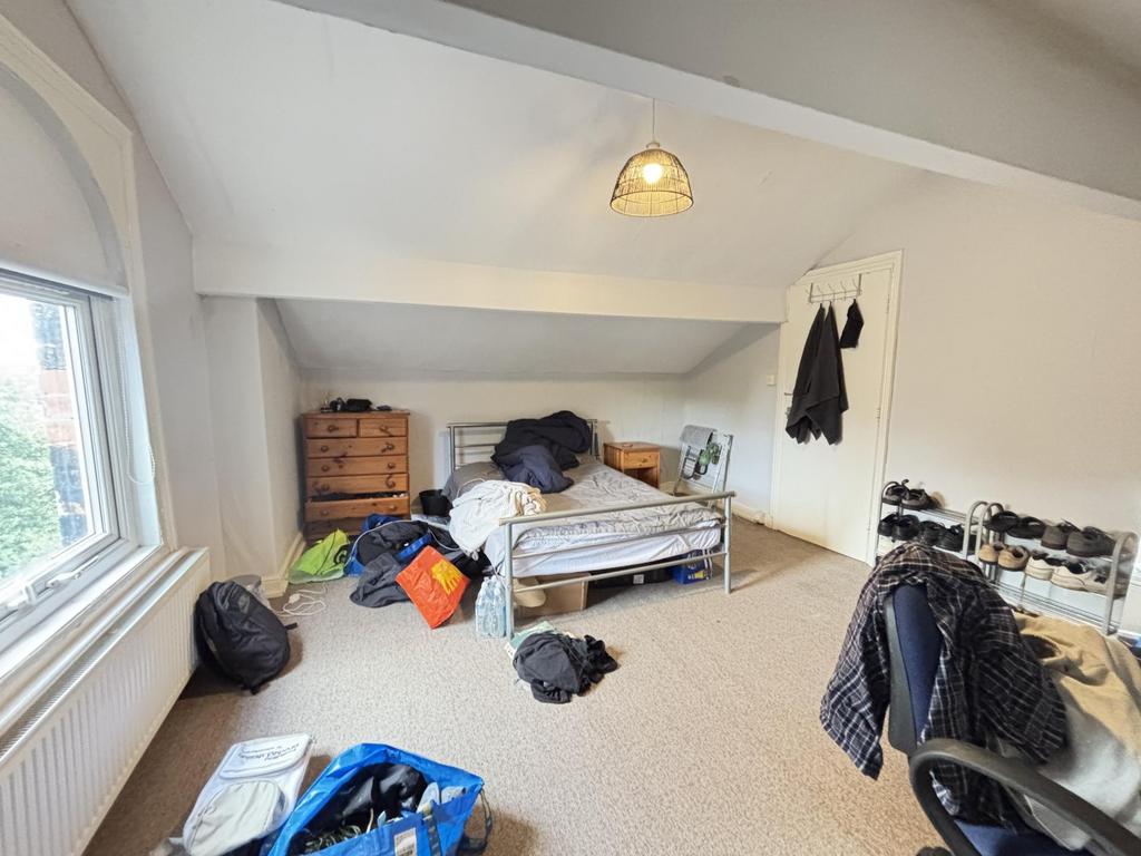 A cozy bedroom with natural light coming throug...