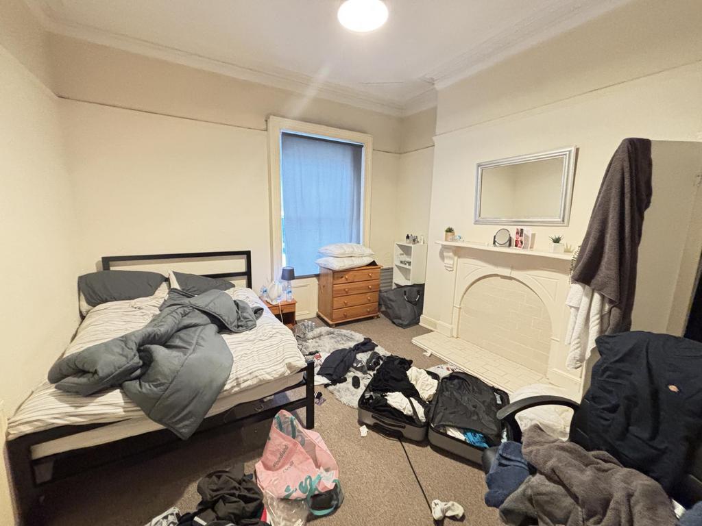 A well-used bedroom with a double bed and some ...