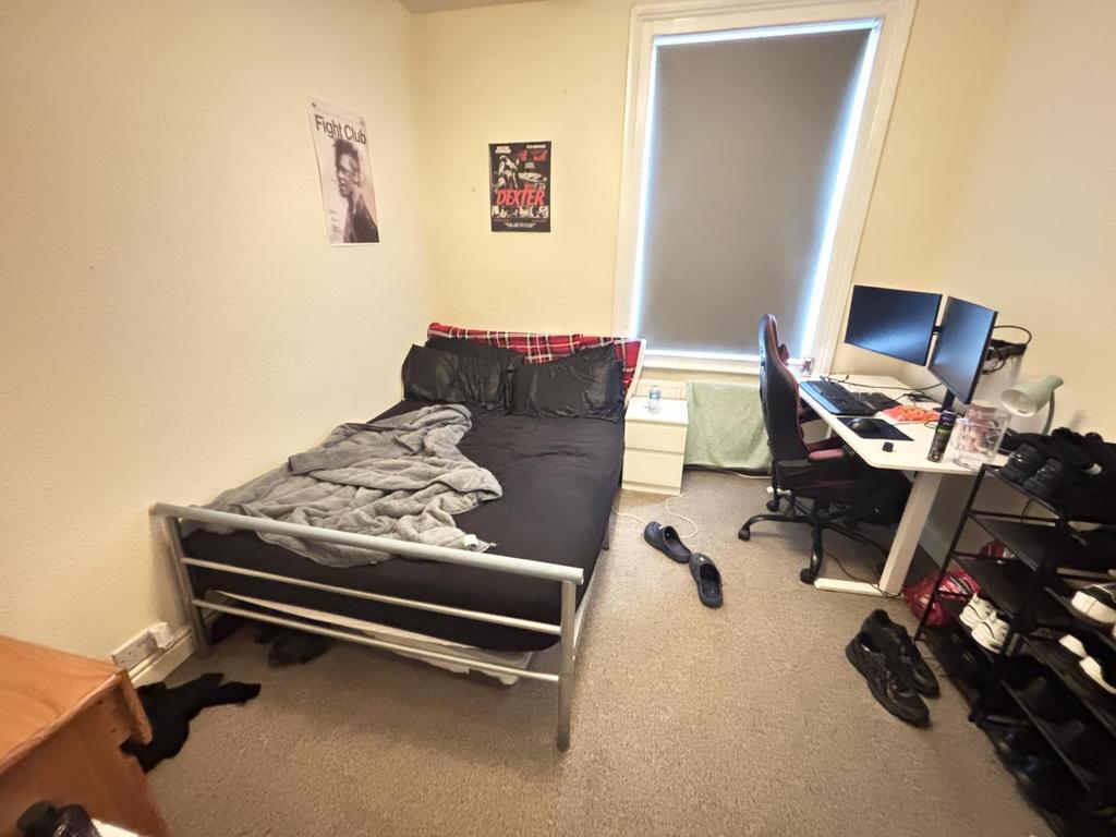 A compact and functional room with basic furnis...
