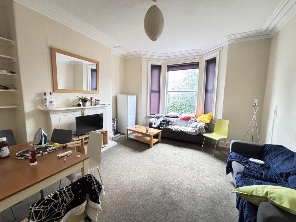 Bright and spacious living room featuring large...
