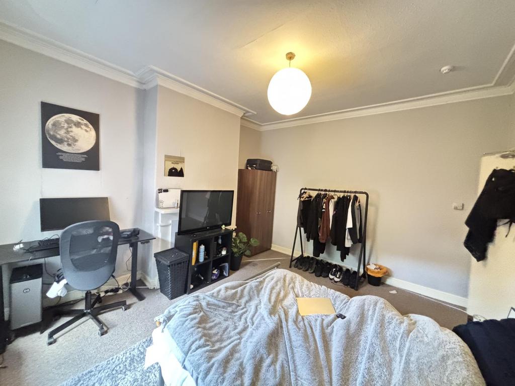 A comfortably furnished bedroom with a bed, a d...