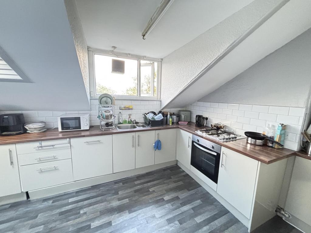 A modern kitchen with ample natural light, clea...