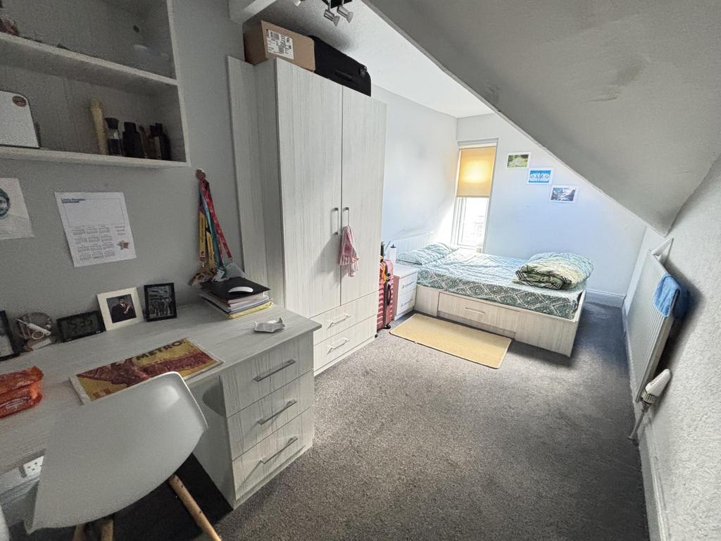 A bright and well-organized bedroom with a comf...