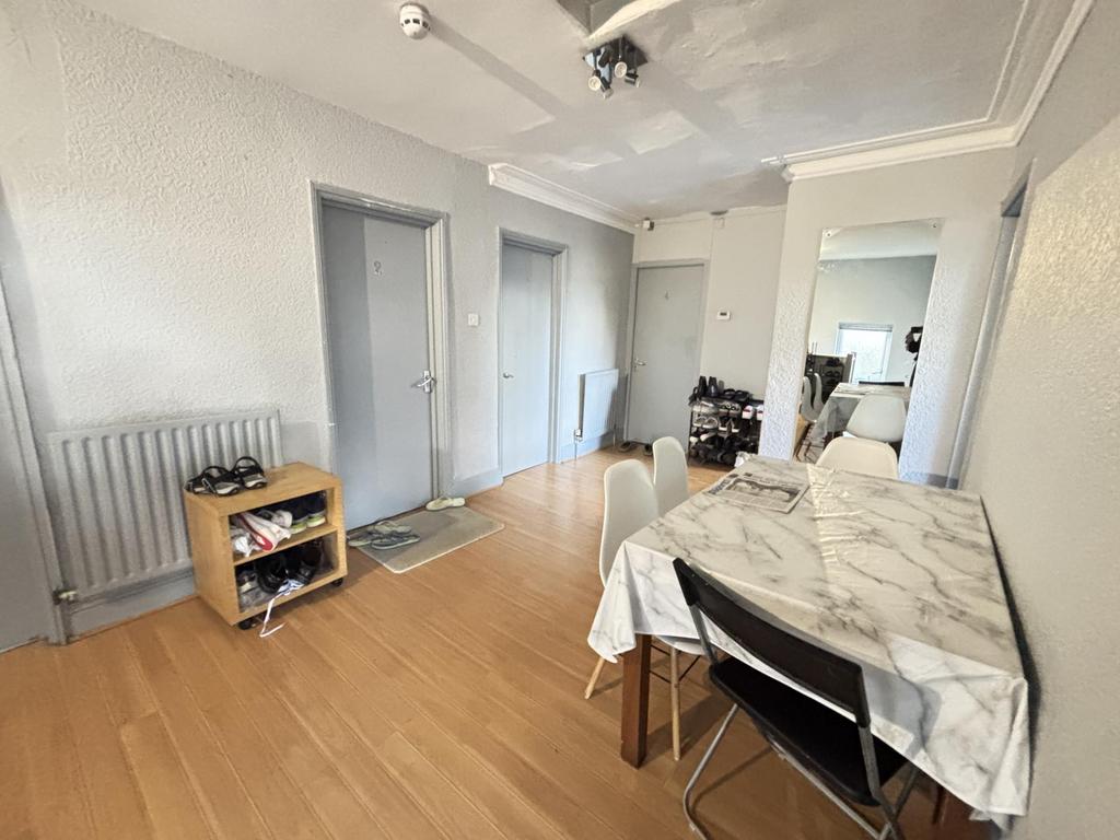 A spacious and well-lit living room featuring c...