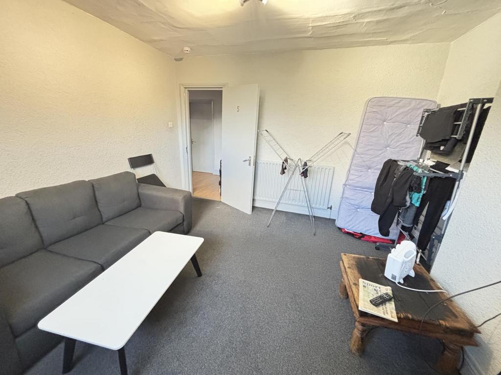 A spacious and comfortable living room featurin...