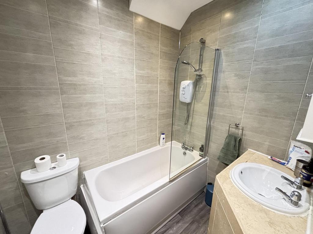 A modern and clean bathroom featuring a bathtub...