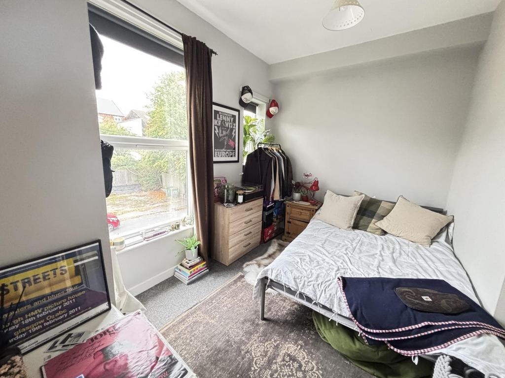 A well-lit spacious master bedroom featuring a ...