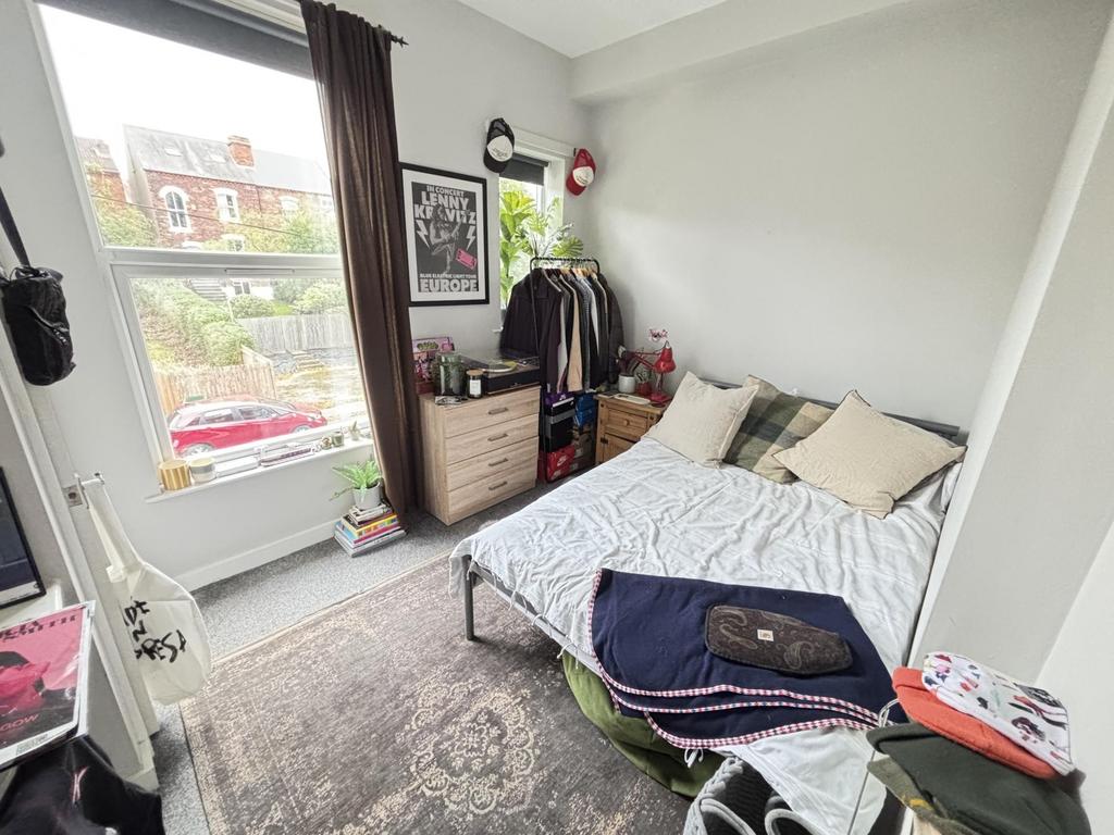 Bright and welcoming master bedroom featuring a...