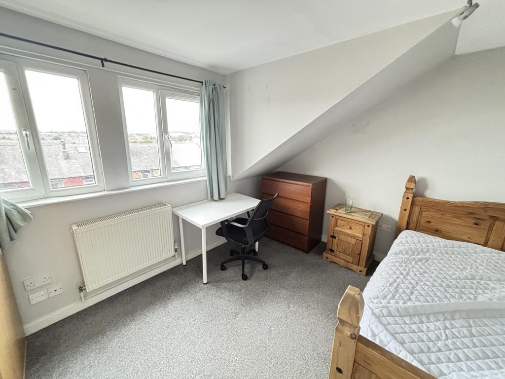 A cozy and well-maintained bedroom featuring a ...