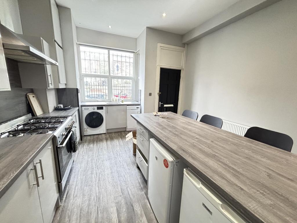 A modern kitchen with a cutting board on the is...