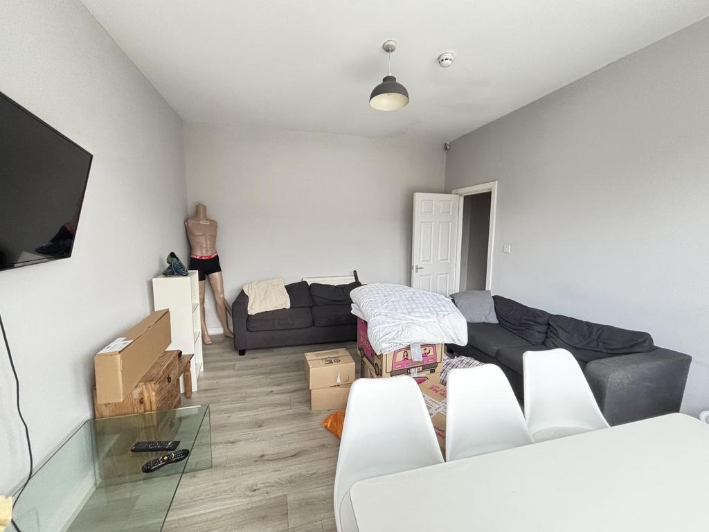 A spacious, well-lit living room with a contemp...