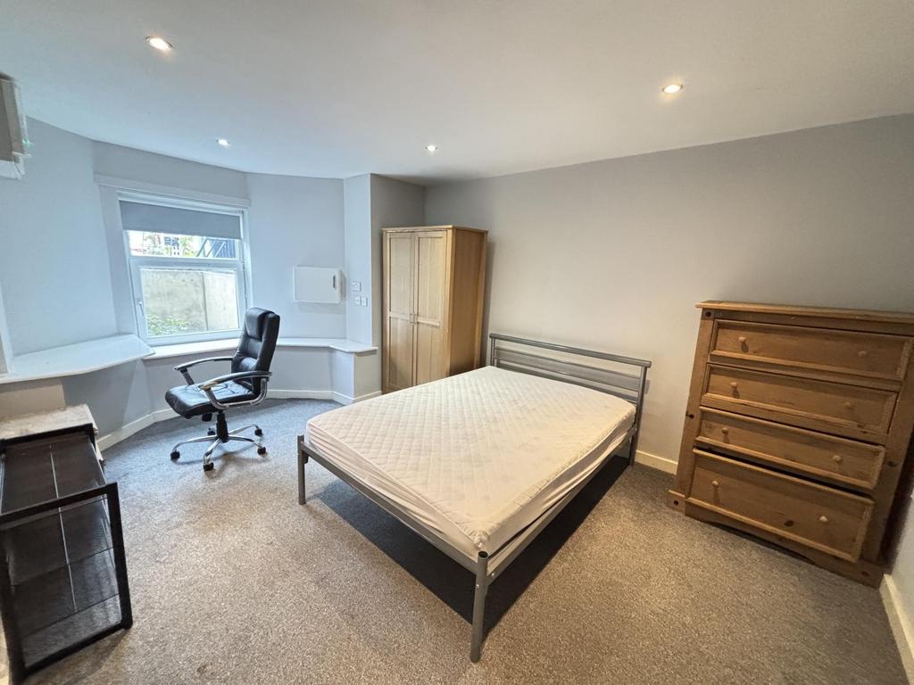 A well-maintained bedroom featuring a double be...