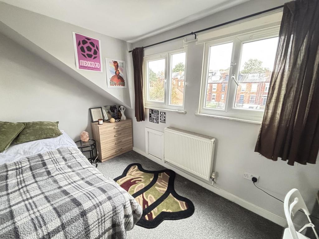 A bright and inviting bedroom with a comfortabl...