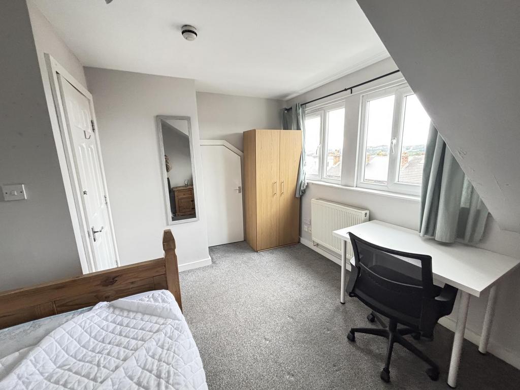 A bright and welcoming student bedroom featurin...