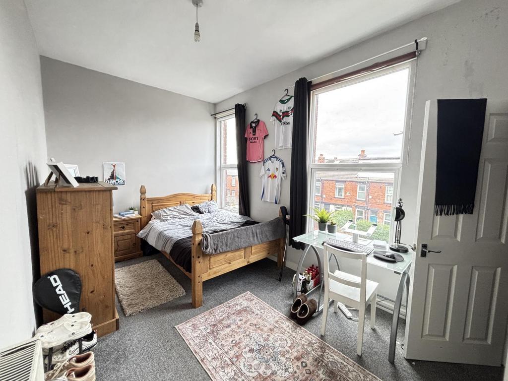 A bright, well-maintained bedroom featuring two...