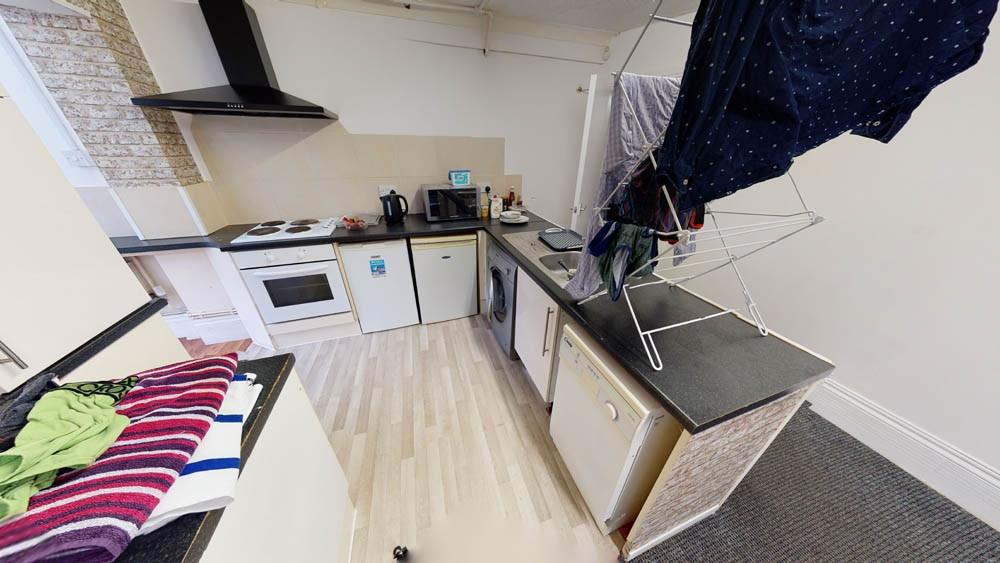 A modern kitchen area with a compact layout, fe...