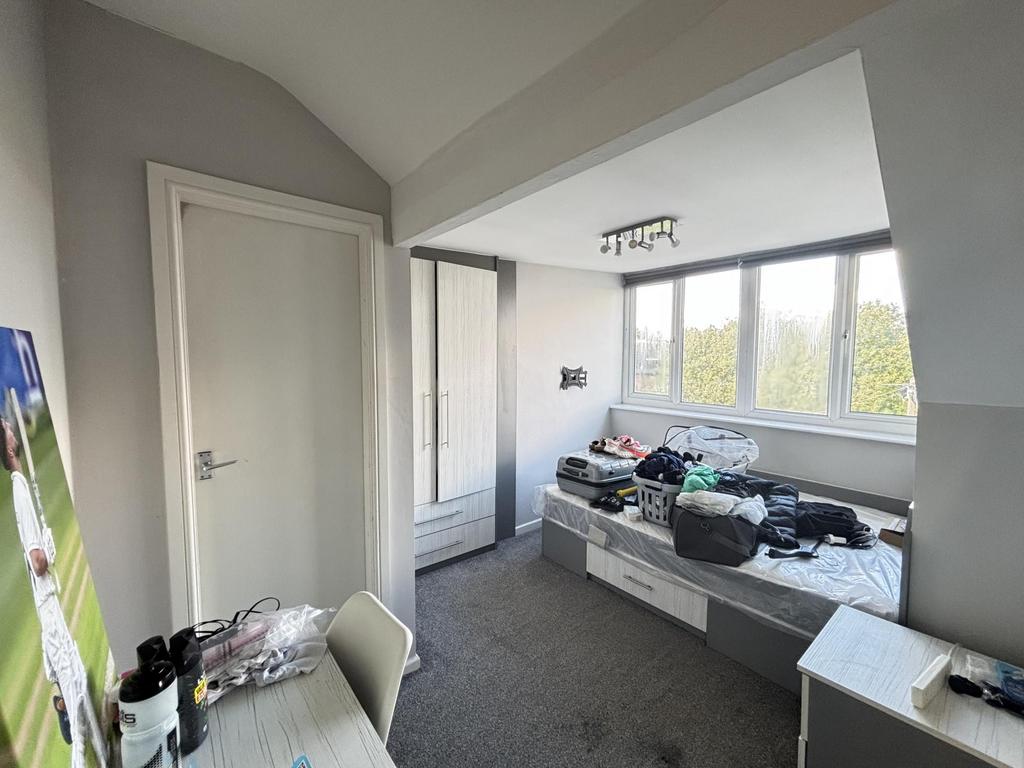 Bright and inviting master bedroom with ample n...
