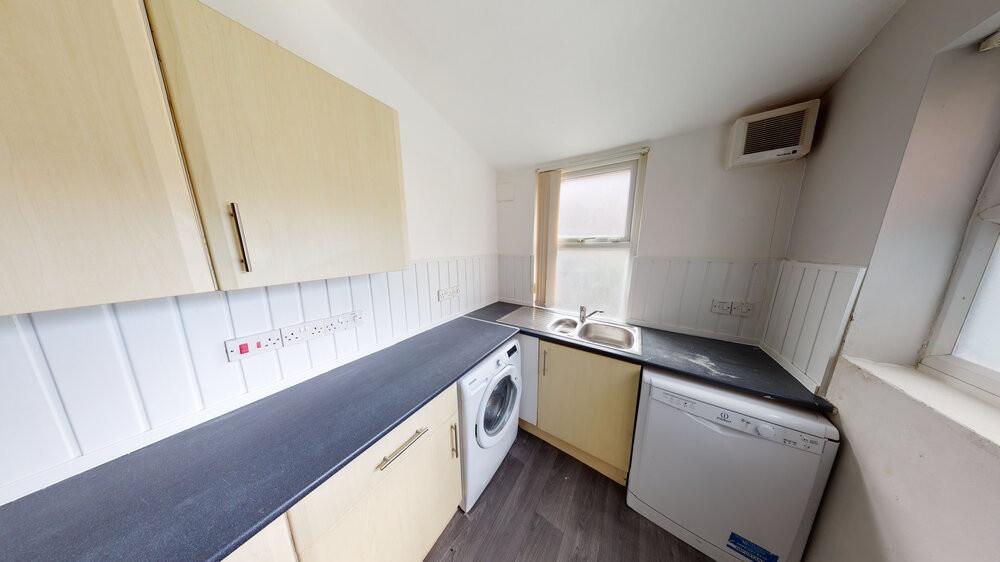 A well-maintained kitchen with ample natural li...