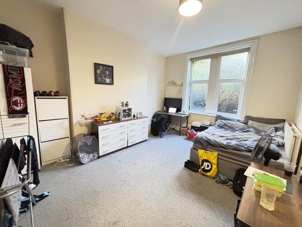 A bright and welcoming living room with large w...