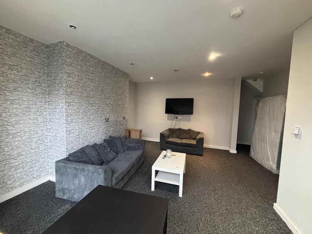 A spacious and modern living room featuring com...