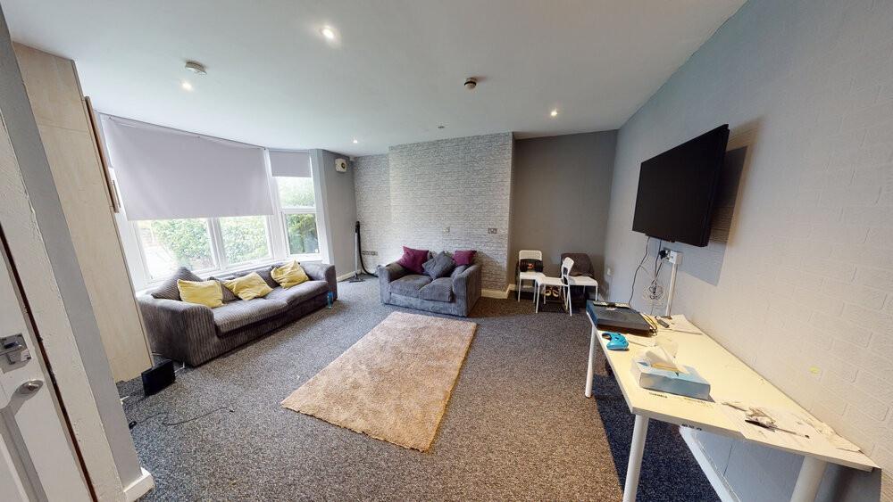 A spacious and well-lit contemporary living roo...