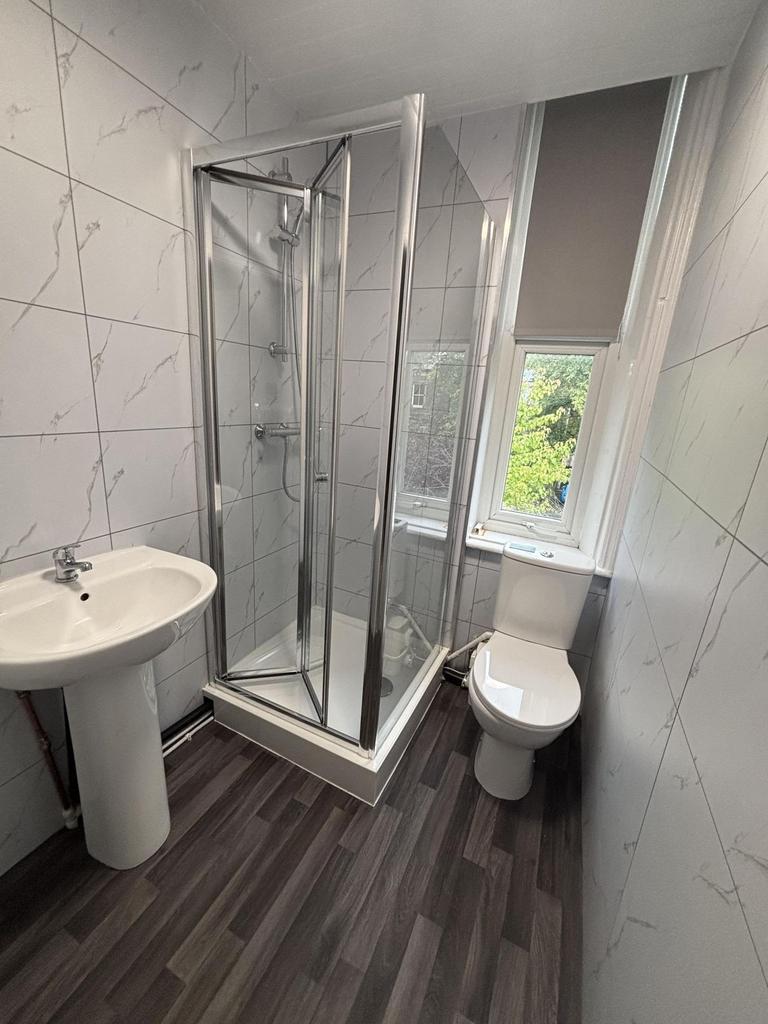 A clean and modern bathroom with a stylish show...