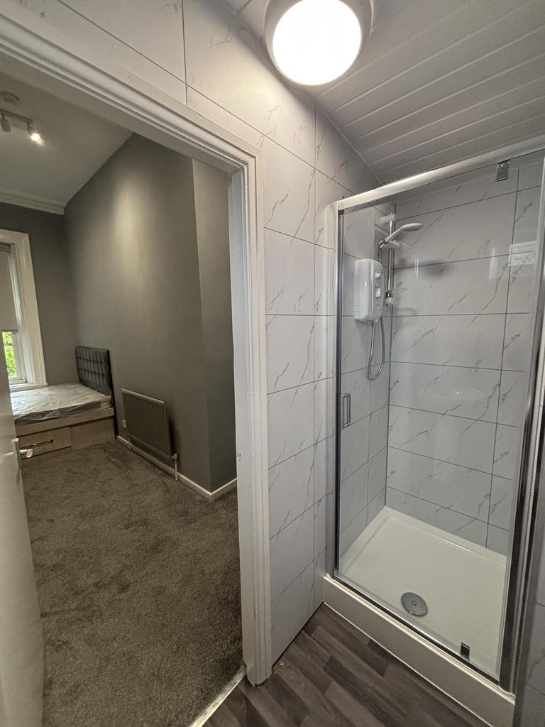 A clean and modern bathroom with a glass enclos...