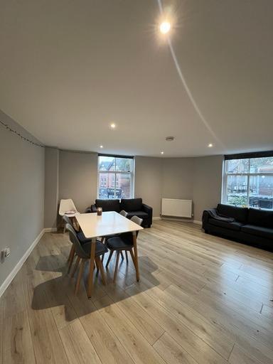 Spacious and modern living area with ample natu...
