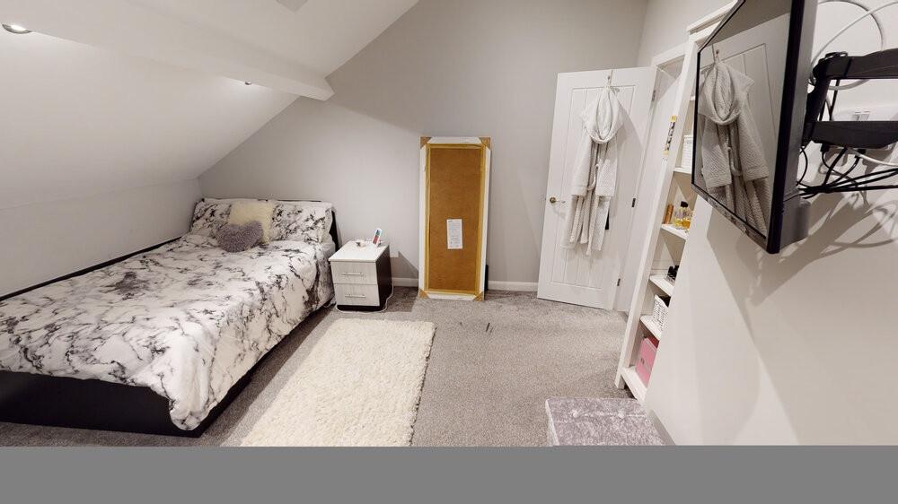 A bright and cozy bedroom featuring a large dou...