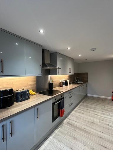 A modern, well-maintained kitchen with sleek ca...