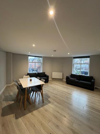 A bright and spacious living area with large wi...