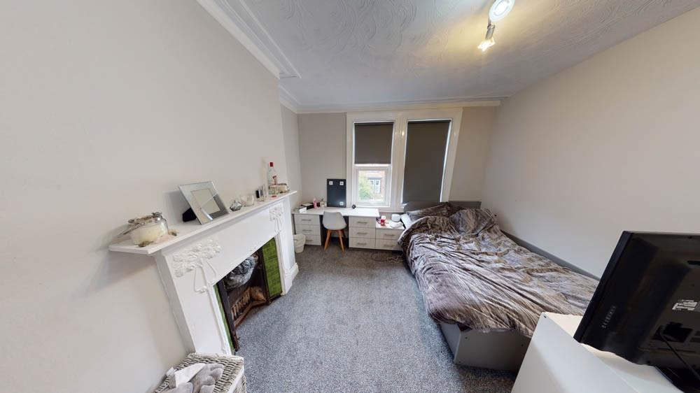 Bright and tidy bedroom featuring a cozy double...