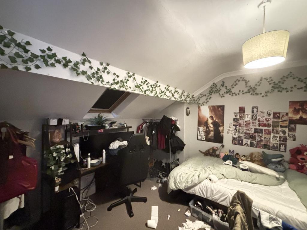 A cozy student bedroom featuring a bed and pers...