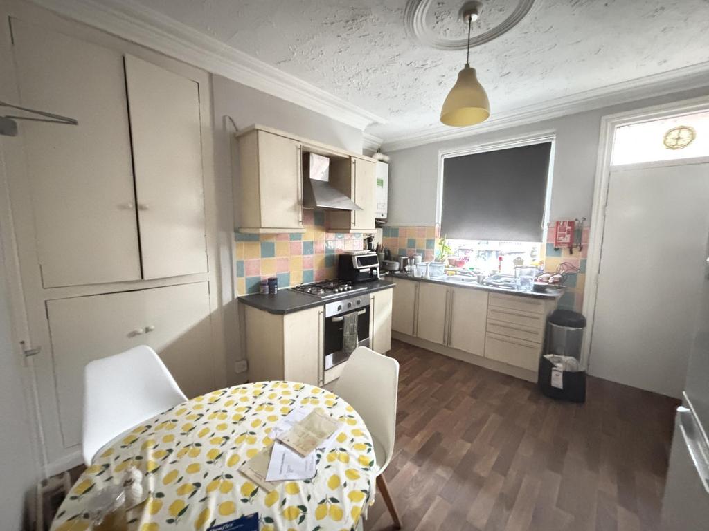 A compact kitchen area with a small dining tabl...