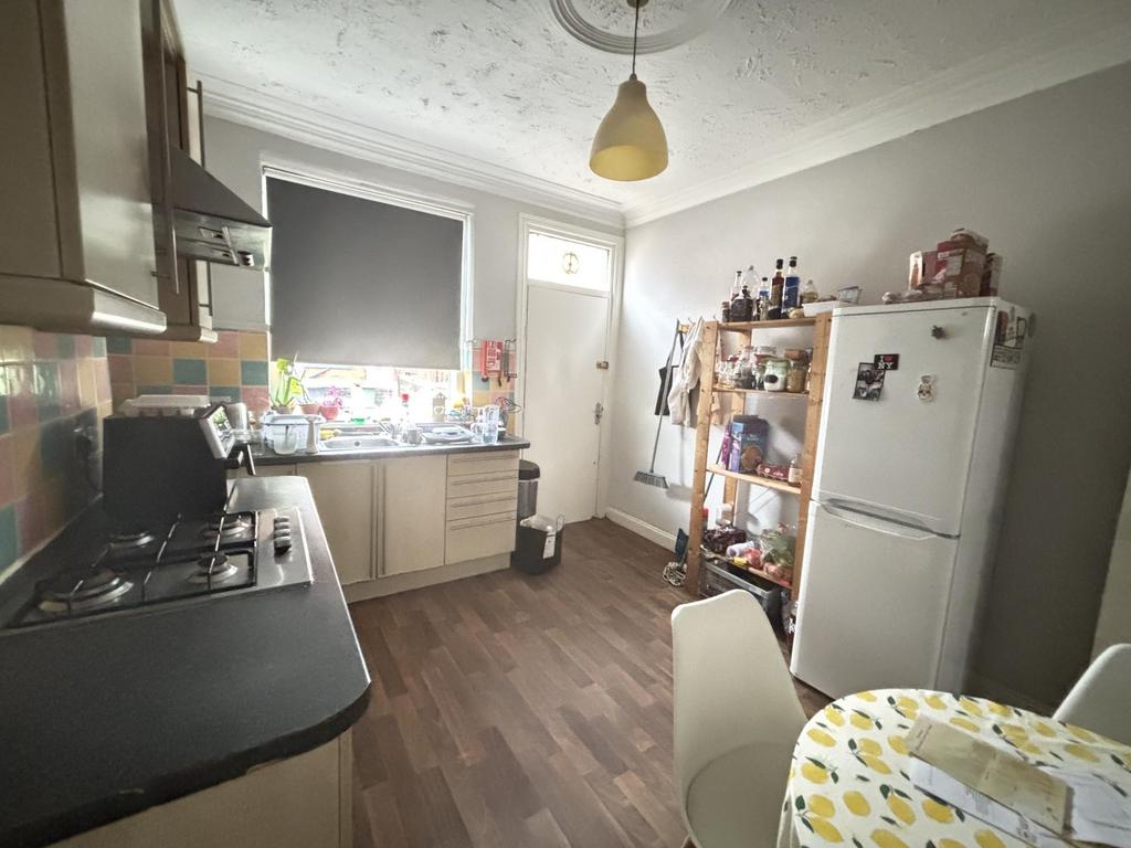 Bright, well-equipped kitchen with modern appli...