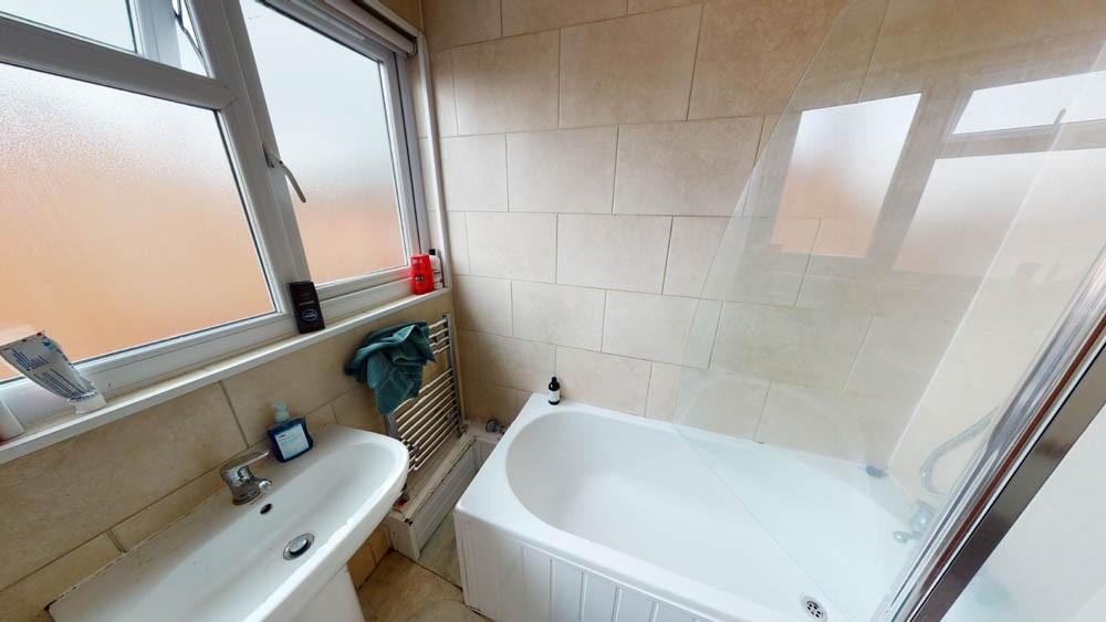 Bright and clean bathroom featuring a spacious ...