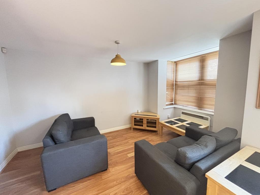 A modern, well-lit living room featuring comfor...